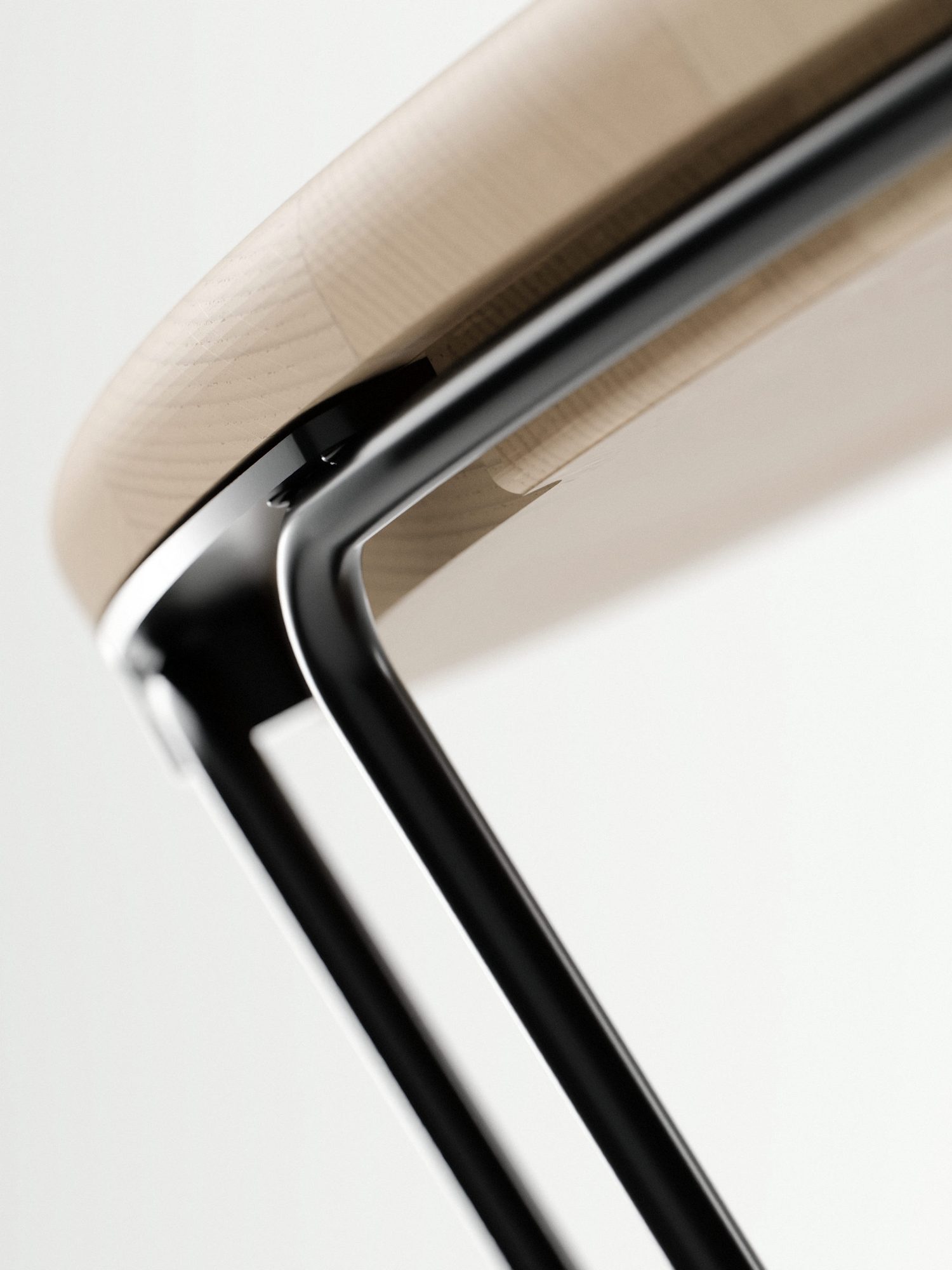 Close-up of the oak top's edge resting on the black wire frame