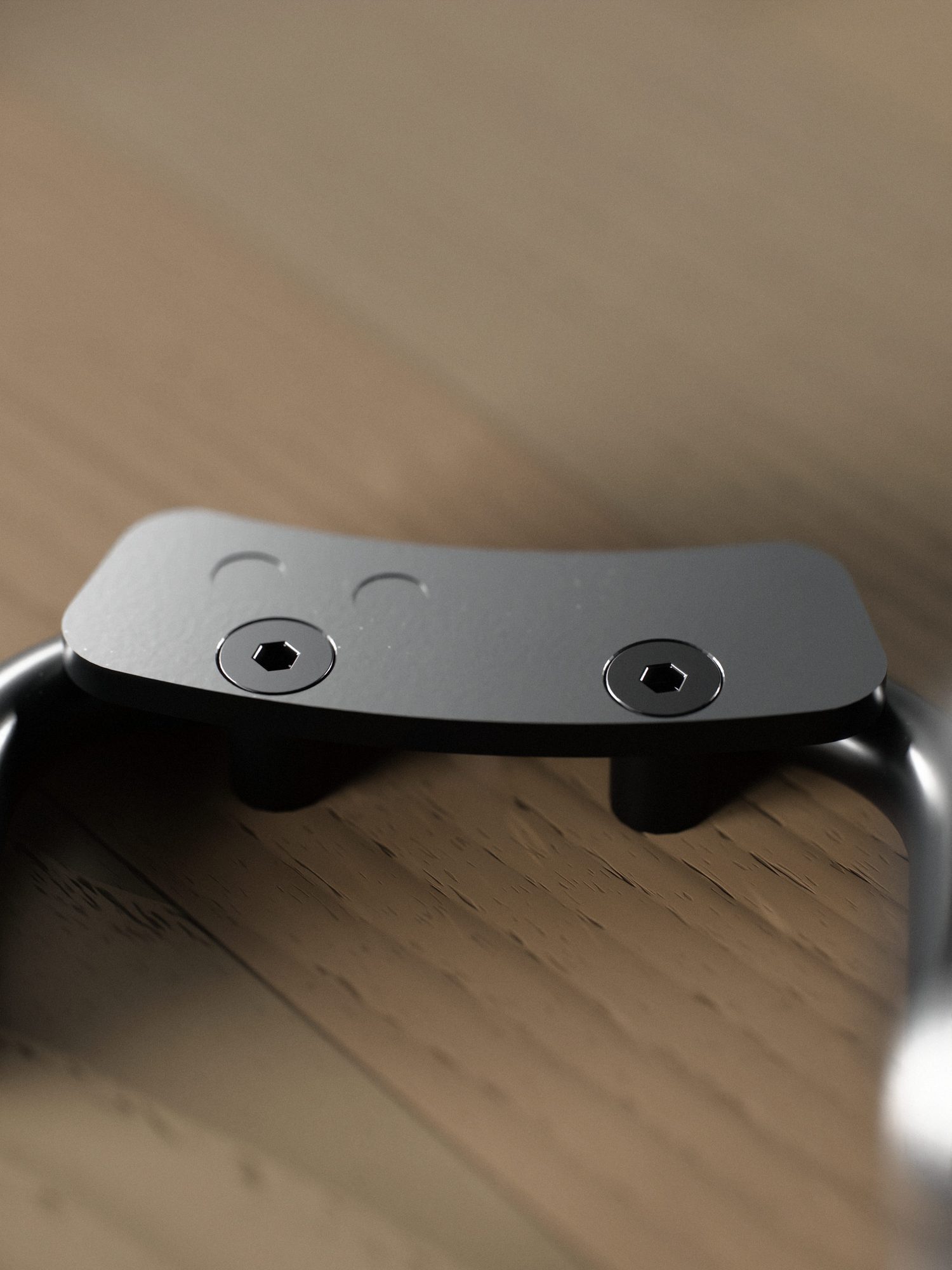 Close-up under the shelf: a black steel plate spot-welded to one wire piece, two countersunk hex screws into the oak