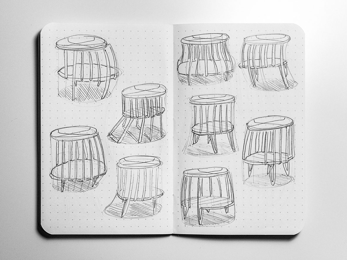 Open sketchbook with nine pencil sketches of round side tables with wire legs